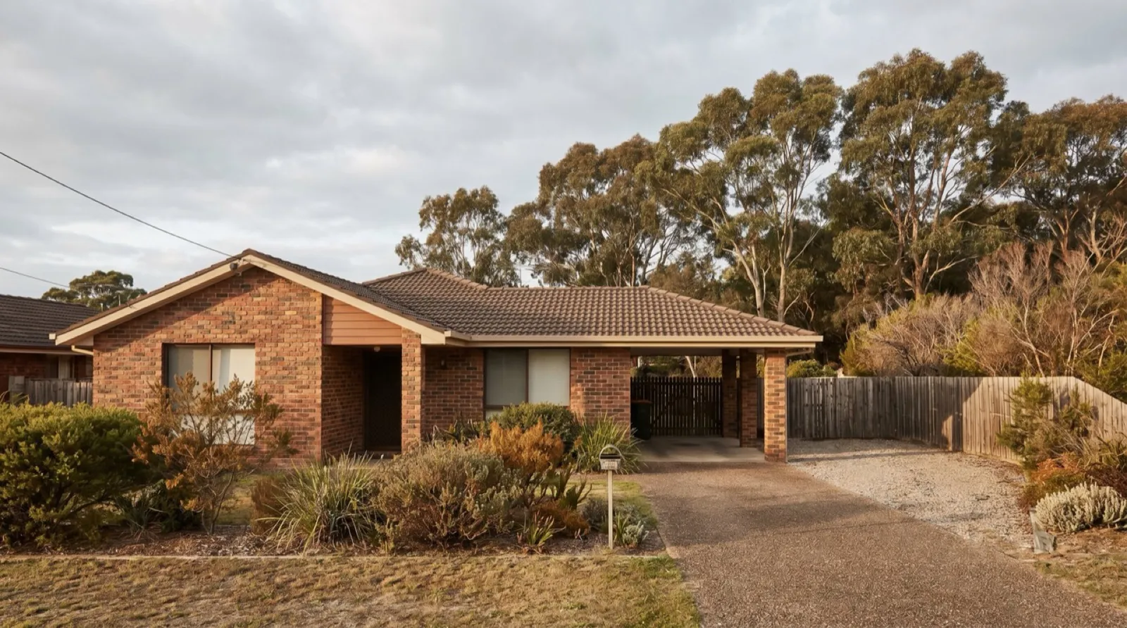 A brick-veneer home backing onto bushland in Wallsend